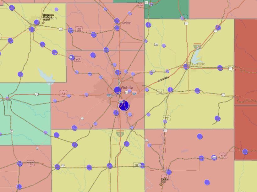 Map of Kansas counties showing dominant industry and insurance coverage rates